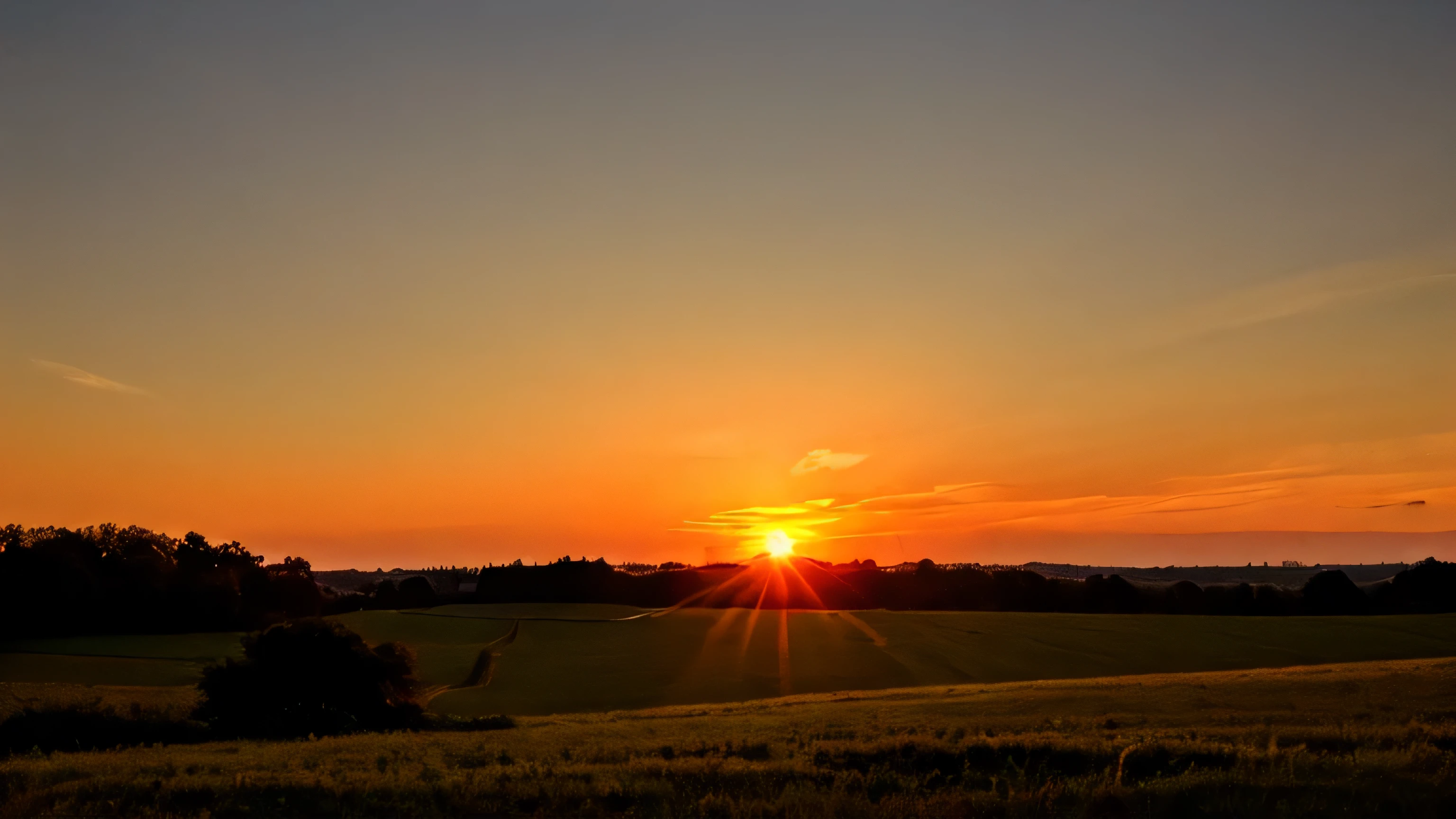 Countryside at dawn with sun peaking over the horizon
