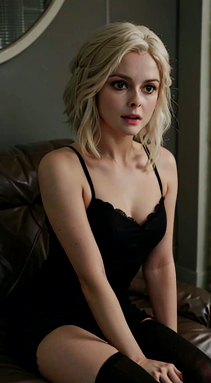 Olivia Moore from the series iZombie sitting on the couch in a short black dress, black stockings and high heels