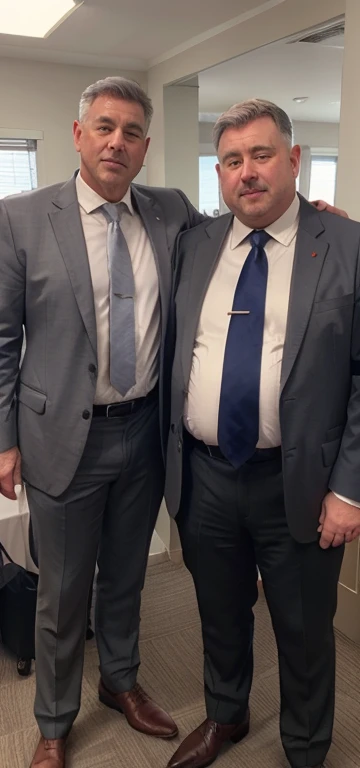 two men in suit and tie standing next to each other, white shirt, grey suit, silk necktie, full windsor necktie, big belly, fat belly, rounded belly, big stomach, robust stocky body, jacket over shirt and tie, man in his 60s, man in his 60s, belly, grey hair