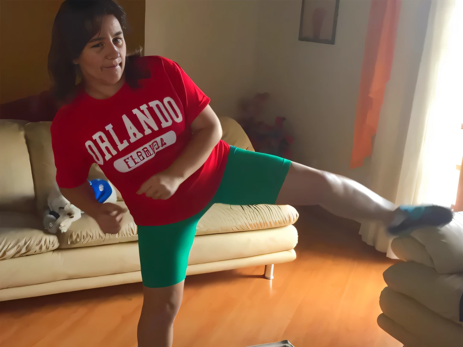 there is a woman in a room, in front of a beige sofa, wearing green shorts and a red t-shirt, she is facing the camera. Slim woman with thin waist. Her body exudes glamor and her face is the definition of beauty. Test, highly realistic, reddish skin, beautiful, slightly full lips, red lipstick, feeling of lightness and joy, hyper-realism, very elaborate skin, direct look. Full body photo, clear and high quality photo. Beautiful woman, extremely sexy, very sensual. Masterpiece: 1.3, high resolution, (photographically realistic), 8k, NUDE, NUDITY, NFSW.