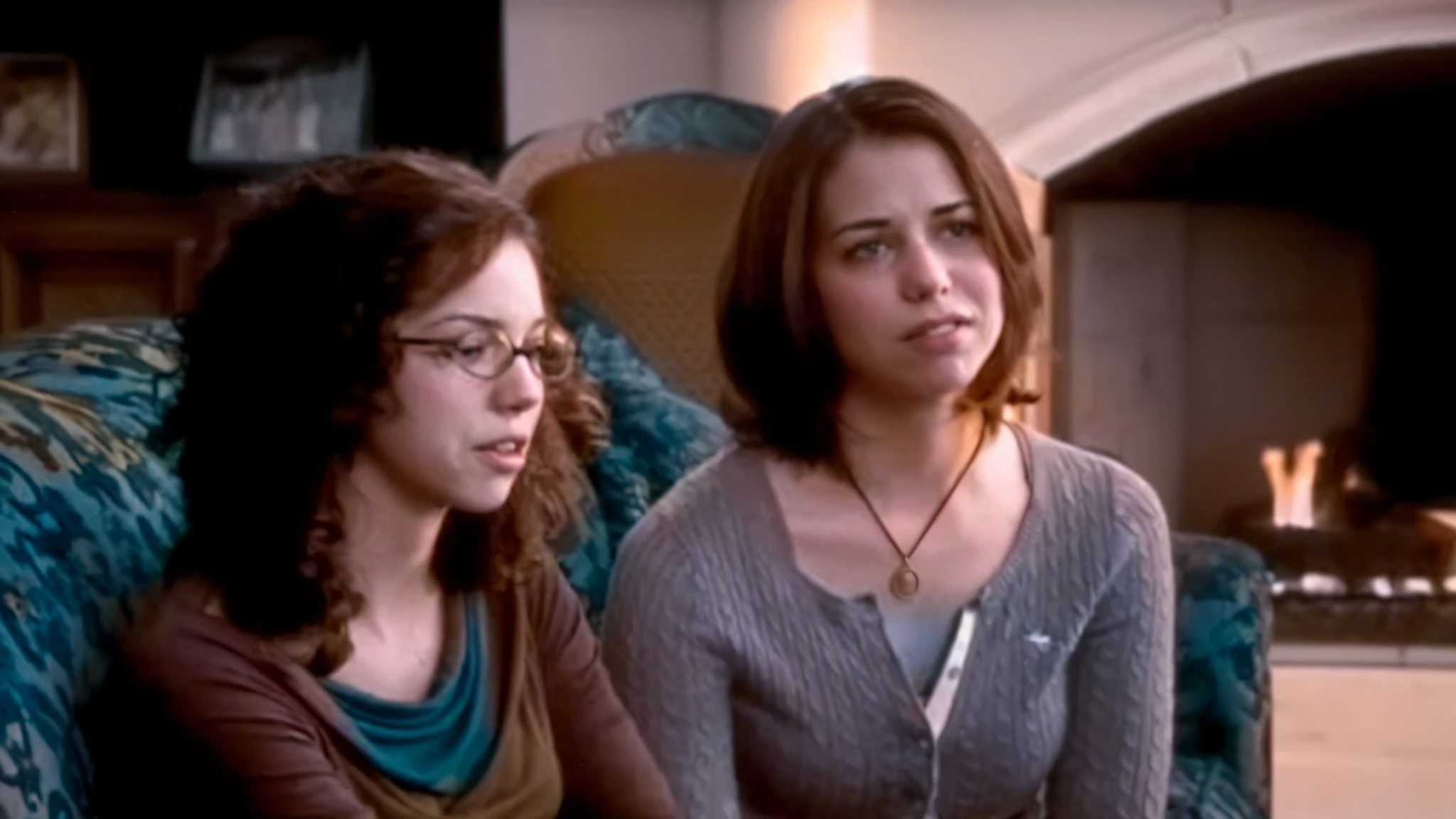 two women sitting on a couch in a living room, they are very serious, still frame from a movie, movie screencap, high quality film still, screenshot from a movie, sisters, favorite scene, still shot from movie, an film still, two girls, shot from movie, still from a movie, still image from tv series, documentary still, movie screen shot