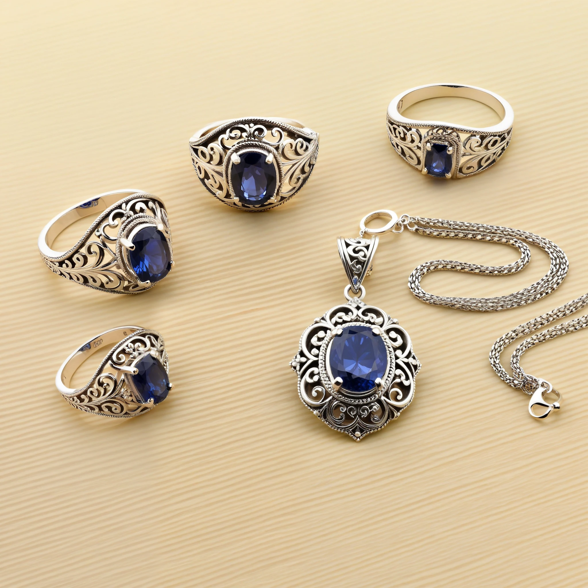 Highly detailed, photorealistic image of a pair of vintage-inspired silver earrings with delicate filigree and sapphire accents; a matching silver ring with a central sapphire and filigree band; and a silver necklace with a sapphire pendant encased in filigree. None of the pieces touch each other, full view of each piece. Professional display.