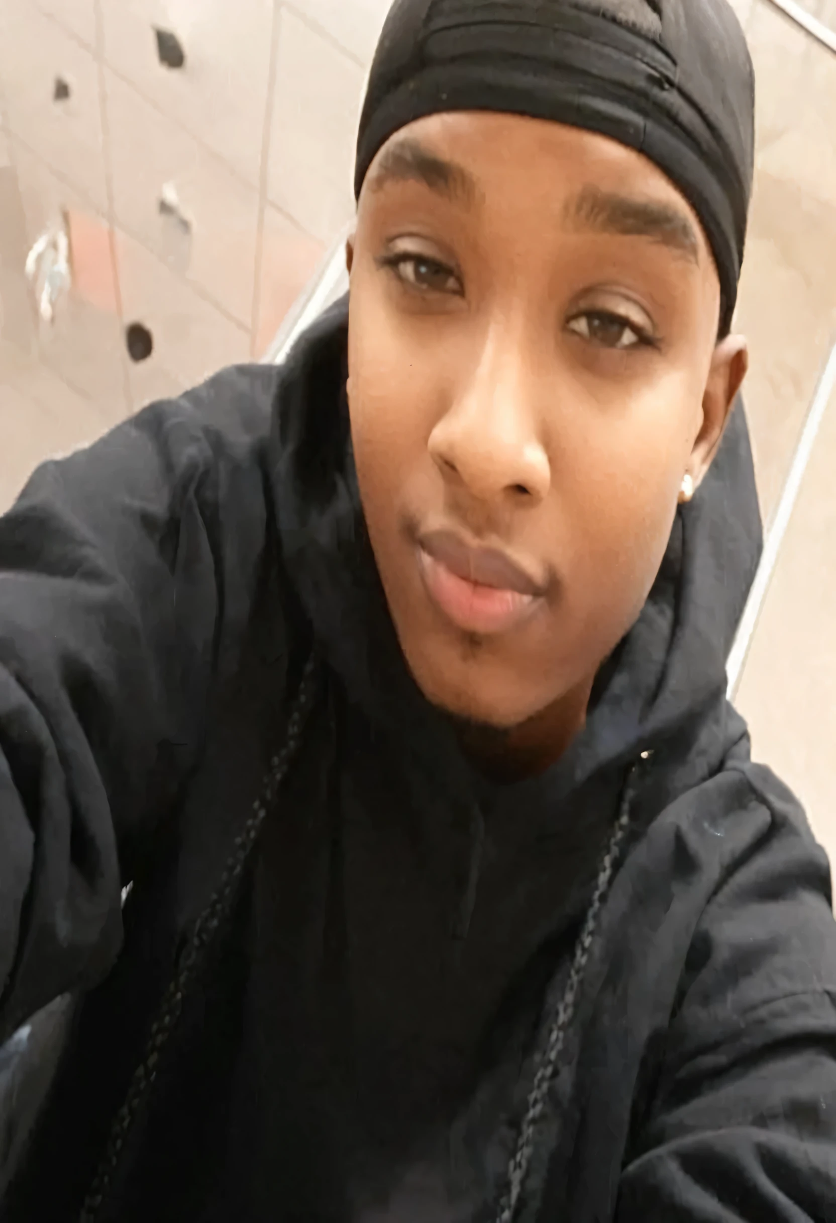 Create a sea art prompt for a black female that dresses as a male and is standing wearing baggy blue jeans long red tshirt high top Jordan shoes red and black holding a basketball