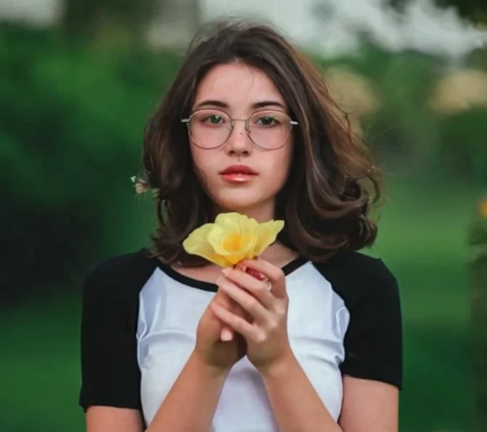 Girl holding flowers outdoor scene