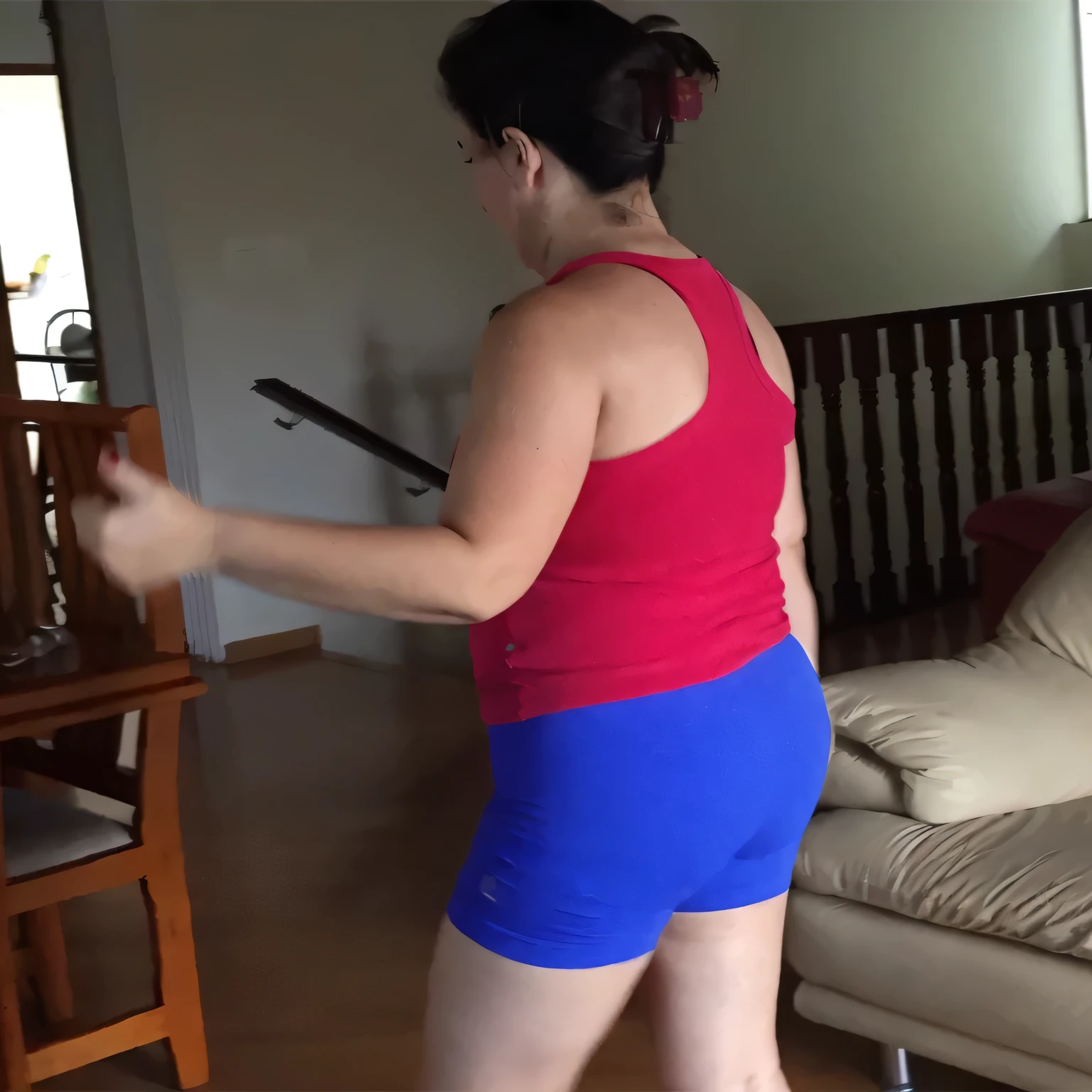 A beautiful light brunette woman, black hair, red tank top and blue shorts playing wii in the living room, attacking the camera: 4, leg and hip shot, photo taken from behind, her back is turned, side view of her taking steps . (ultra quality masterpiece) with toned body, 35 years old, 1.62 tall, 60 kg, best quality, perfect face, perfect mouth, perfect hands, (((black hair))), is standing, ( full body) wearing a tank top (((red top)) )), short blue shorts (((short blue shorts)))), dark brown hair, short blue shorts for gym training, tanned body, sexy pose, good legs shapely, well-defined, high contrast, Ultra HD, high contrast, 16K. photorealistic, detailed and realistic hands, 5 fingers per hand, alone, dark hair, green thong bikini, full body photo, clear, high quality photo. Beautiful woman, extremely sexy, very sensual. Masterpiece: 1.3, high resolution, (photographically realistic), 8k, NUDE, NUDITY, NFSW.