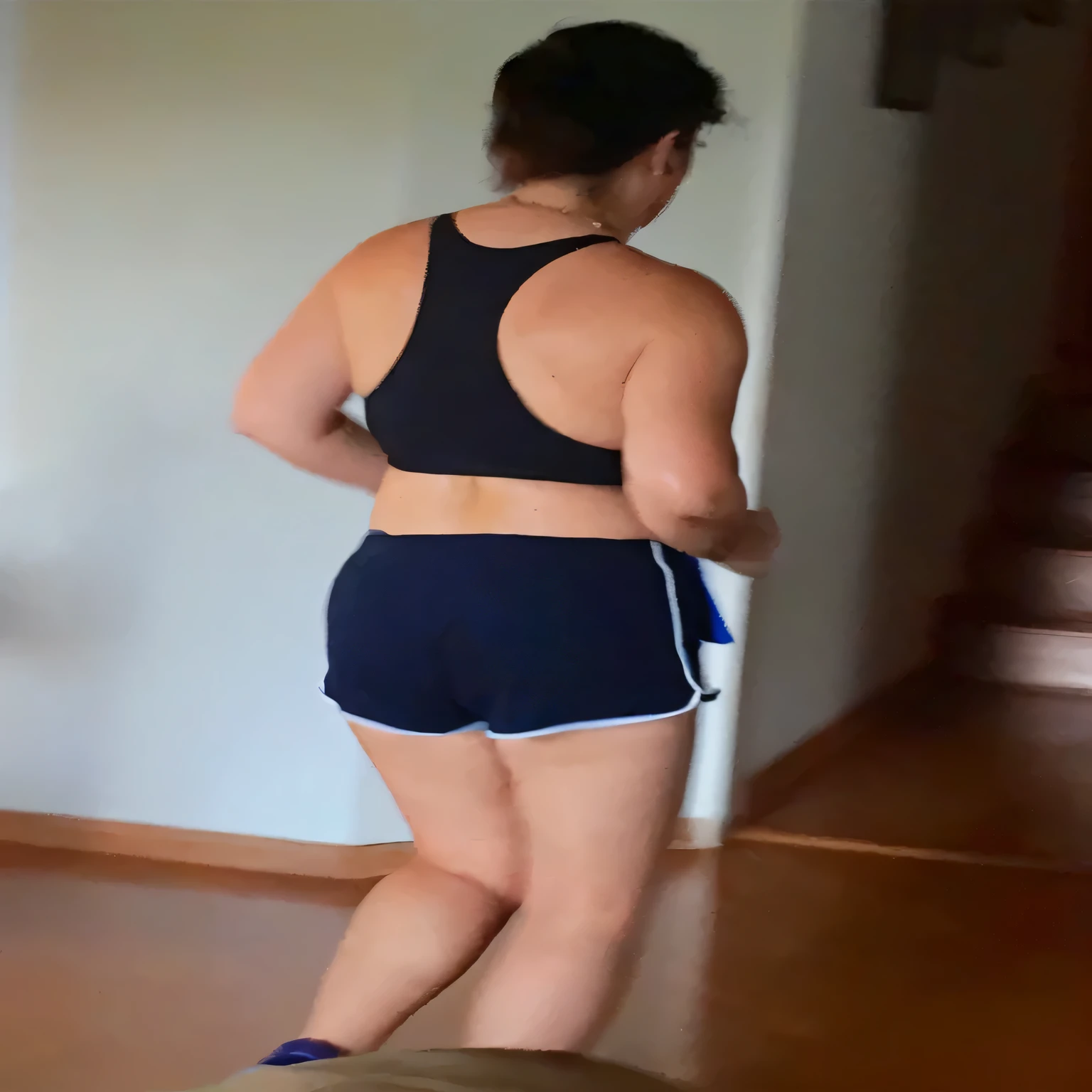 A beautiful light brunette woman, black hair, black tank top and blue shorts playing Wii in the living room, attacking the camera: 4, photo of legs and hips, photo taken from behind, side view of her taking steps. (ultra quality masterpiece) with toned body, 35 years old, 1.62 tall, 60 kg, best quality, perfect face, perfect mouth, perfect hands, (((black hair))), is standing, ( full body) wearing a tank top (((black top)) )), short blue shorts (((short dark blue shorts)))), dark brown hair, short dark blue shorts for gym training, tanned body, sexy pose , shapely legs, well defined, high contrast, Ultra HD, high contrast, 16K. photorealistic, detailed and realistic hands, 5 fingers per hand, alone, dark hair, green thong bikini, full body photo, clear and high quality photo. Beautiful woman, extremely sexy, very sensual. Masterpiece: 1.3, high resolution, (photographically realistic), 8k, NUDE, NUDITY, NFSW.