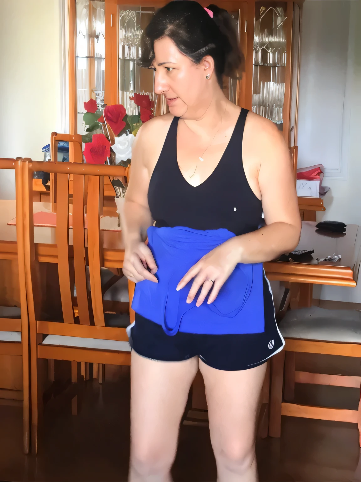 A beautiful light brunette woman, black hair, black tank top and blue shorts playing Wii in the living room, attacking the camera: 4, photo of legs and hips, photo taken from the front, side view of her taking steps. (ultra quality masterpiece) with toned body, 35 years old, 1.62 tall, 60 kg, best quality, perfect face, perfect mouth, perfect hands, (((black hair))), is standing, ( full body) wearing a tank top (((black top)) )), short blue shorts (((short dark blue shorts)))), dark brown hair, short dark blue shorts for gym training, tanned body, sexy pose , shapely legs, well defined, high contrast, Ultra HD, high contrast, 16K. photorealistic, detailed and realistic hands, 5 fingers per hand, alone, dark hair, green thong bikini, full body photo, clear and high quality photo. Beautiful woman, extremely sexy, very sensual. Masterpiece: 1.3, high resolution, (photographically realistic), 8k, NUDE, NUDITY, NFSW.