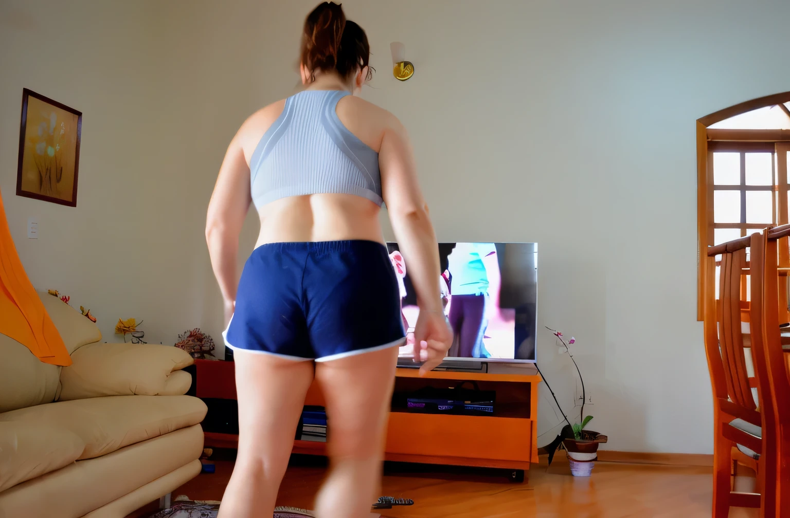 woman in blue shorts standing in front of a television in a living room, sport bra and shorts, sport bra and dark blue shorts, toned derriere, working out, workout, back - shot, shapely toned derriere, in shorts, long shot from the back, rear-shot, back shot, backshot, cottagecore!! fitness body