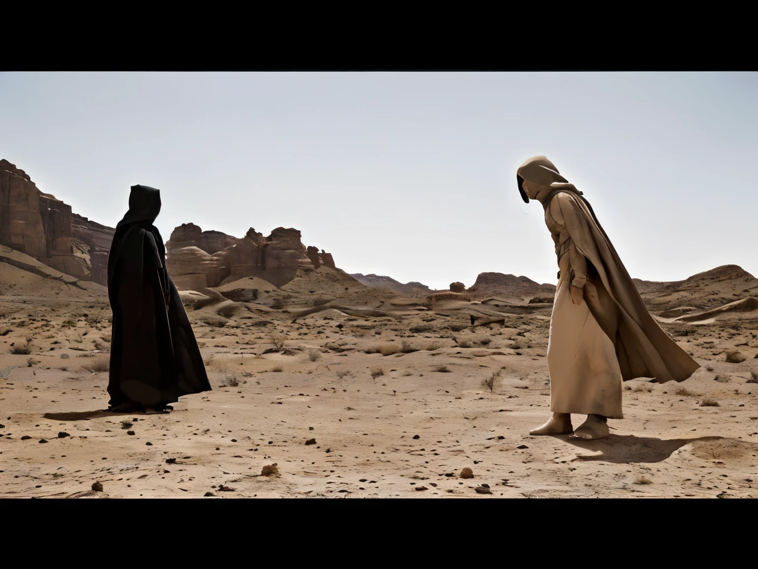 In the image, there are two characters positioned in a barren desert terrain, under a partly cloudy sky. The landscape, devoid of vegetation, has some rock formations in the background, which contributes to a desolate and remote atmosphere.

On the left, a character dressed in a black cape with a hood, which completely covers his body and face, conveys an aura of mystery or threat. This character's posture is erect and motionless, suggesting waiting or contemplation.

On the right, the other character, wearing a beige cloak over a lighter robe and sandals, displays an expression and posture of anguish or despair. He has his mouth open as if he is shouting or calling for someone, and his body is tilted forward, which suggests movement and a possible attempt to approach or confront the character in black.

The interaction between the two characters seems fraught with tension, indicating a possible confrontation or a significant moment of disagreement or revelation. The choice of costume colors—black versus shades of beige—can symbolize classic dualisms such as good versus evil or light versus dark.

The lighting and desert setting intensify the feeling of isolation and challenge faced by the characters, highlighting the drama of the scene. The photography uses a wide perspective to emphasize the vastness of the environment and the distance between the characters, increasing the feeling of desolation and internal or external conflict.