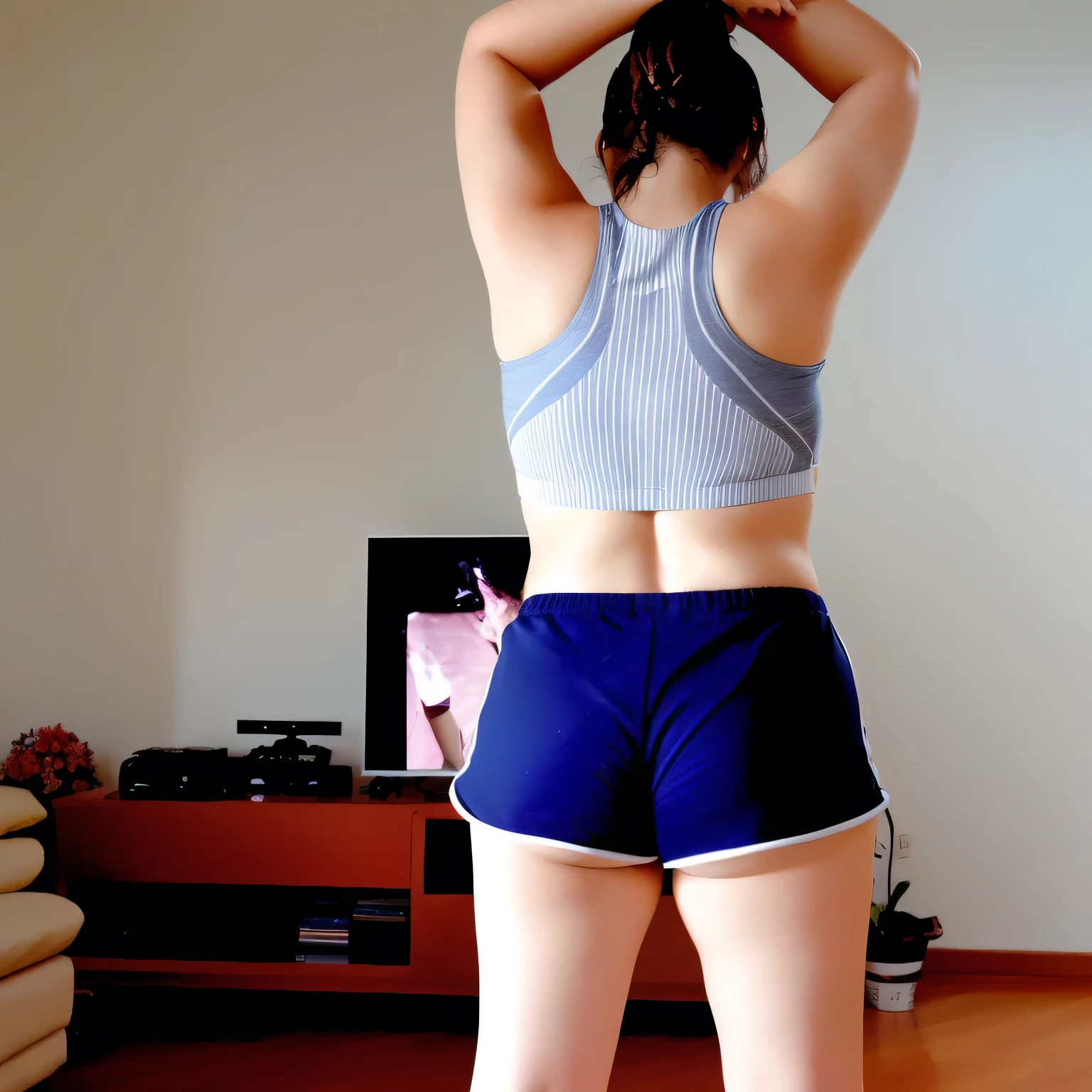 there is a woman who is playing with a remote control, sports bra and dark blue shorts, with her arms up, photo taken from = back, toned butt, working out, back pose, in action pose, back photo, back photo, sports bra and shorts, rear view!!, with arms up, toned bottom, striking a cheeky, extremely hot and sexy pose. back photo, toned back, back photo, from behind. Beautiful woman, perfect body, 38 years old, beautiful woman, dark brown eyes, ((beautiful slim woman, 38 years old, hair color [black hair], thin waist, charming, fair skin, (sexy), (detailed face) , detailed eyes, ,(hot), beautiful body and soft, voluptuous woman, crop top, thong, shorts, ((full body))