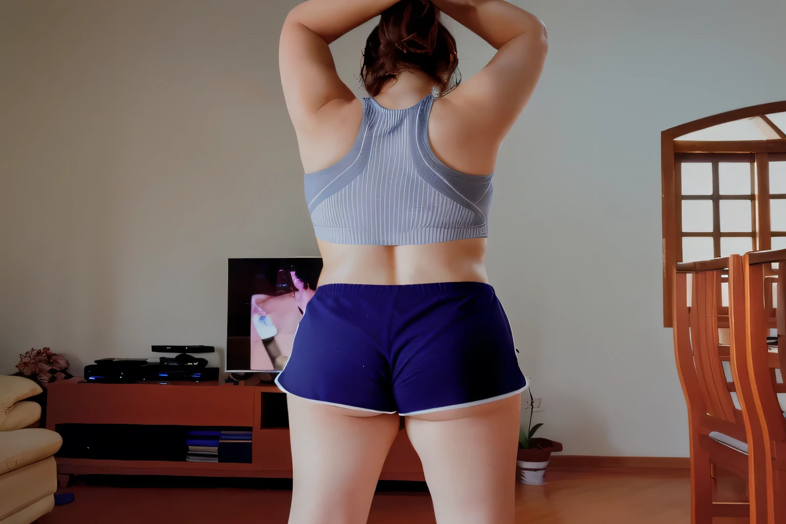 there is a woman who is playing with a remote control, sports bra and dark blue shorts, with her arms up, photo taken from = back, toned butt, working out, back pose, in action pose, back photo, back photo, sports bra and shorts, rear view!!, with arms up, toned bottom, striking a cheeky, extremely hot and sexy pose. back photo, toned back, back photo, from behind. Beautiful woman, perfect body, 38 years old, beautiful woman, dark brown eyes, ((beautiful slim woman, 38 years old, hair color [black hair], thin waist, charming, fair skin, (sexy), (detailed face) , detailed eyes, ,(hot), beautiful body and soft, voluptuous woman, crop top, thong, shorts, ((full body)). Ultra HD, 16K. Photorealistic, detailed and realistic hands, 5 fingers per hand, dark hair, full body photo, clear and high quality photo. Masterpiece: 1.3, high resolution, (photographically realistic), 8k, NUDE, NUDITY, NFSW.