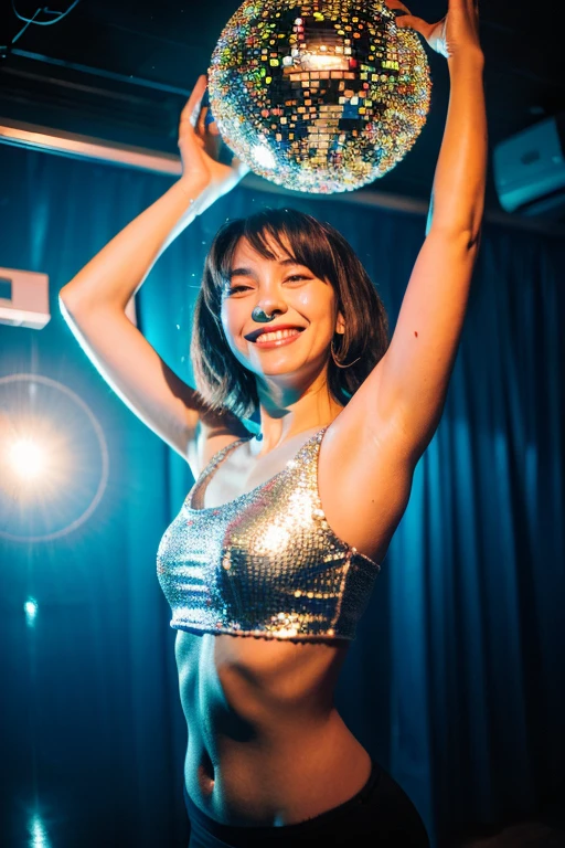 A woman smiling and dancing under a disco mirror ball, upper body