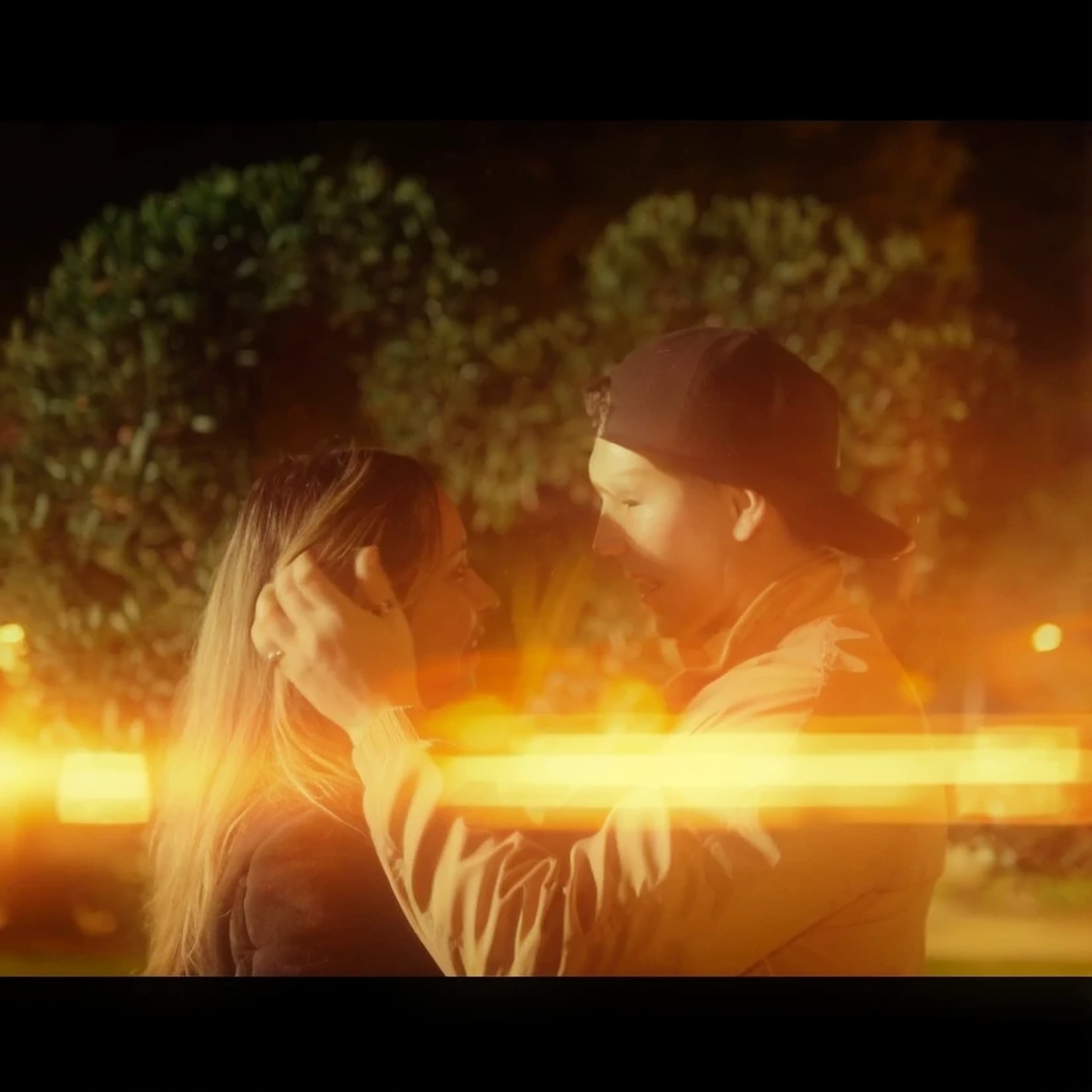 There is a man and a woman who are together on the street, anamorphic canes, anamorphic bokeh and lens flares, anamorphic lens flares, still from a video musical, anamorphic lens flare, Superior bokeh cinematic lighting, Golden hour cinematic, cinematic still frame, video musical, anamorphic lens flares 4k, Screenshot of YouTube video