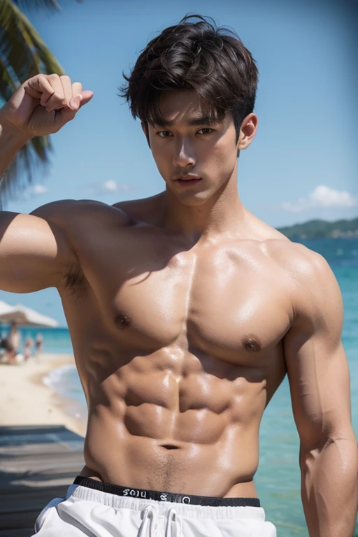 Handsome guy with abdominal muscles on the beach