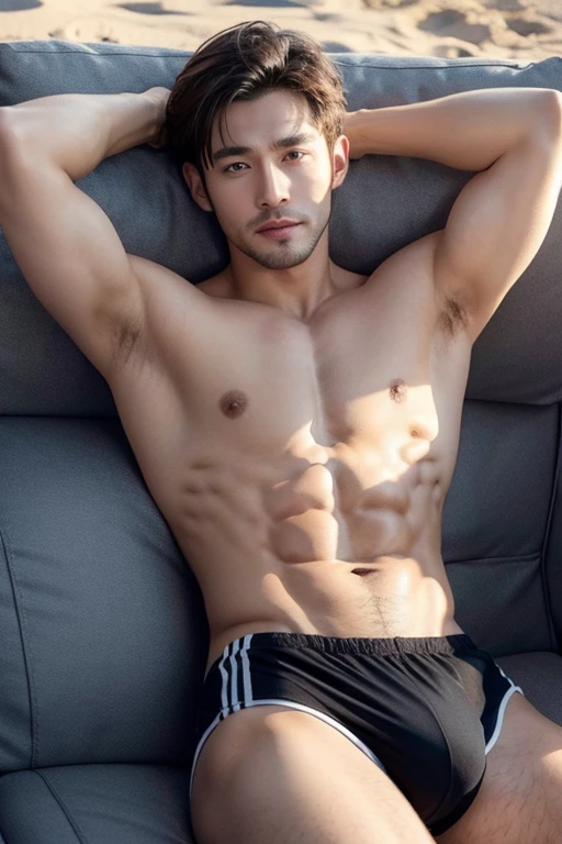Handsome guy with abdominal muscles on the beach