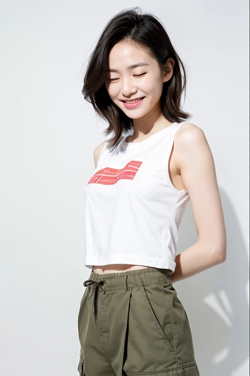 A beautiful and cute middle-aged Japanese woman, an inorganic Snow White background, natural skin, a cute smile with her mouth closed, very short short black hair, a visible forehead, a young-looking face, small build, short stature, White fitted sleeveless T-shirt, cargo pants, natural skin, standing tall, full body photo, serious and honor student atmosphere, correct posture, upper body