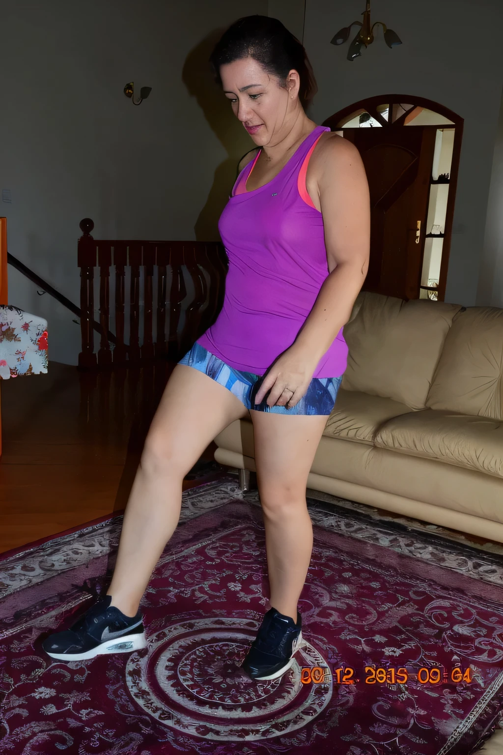 A woman is standing on a patterned red carpet, slightly, leaning forward with her right leg extended forward. A woman stands on one leg, with her body slightly leaning forward and her hand resting on her hip. She is wearing a purple t-shirt and blue shorts, toned legs, wearing a tank top and shorts, paired with black sneakers, suitable photo, hip and leg shot, . Her hair is dark and pulled back. In the background, there is a beige sofa and an arch that leads to another room. Dress with top and shorts. She is about 36 years old, 1.62 tall, 60 kg, best quality, perfect face, perfect mouth, perfect hands, well defined, her slightly plump and red lips look like a delicate flower. Slim body, slim waist. Her body exudes glamor and her face is the definition of beauty. Highly realistic, reddish skin, feeling of lightness and joy, hyper-realism, very elaborate skin. Sharp photo, high quality, high resolution (ultra quality masterpiece), Ultra HD, high contrast, 36K. Masterpiece: 1.3, high resolution, (photographically realistic), 8k, NUDE, NUDITY, NFSW.