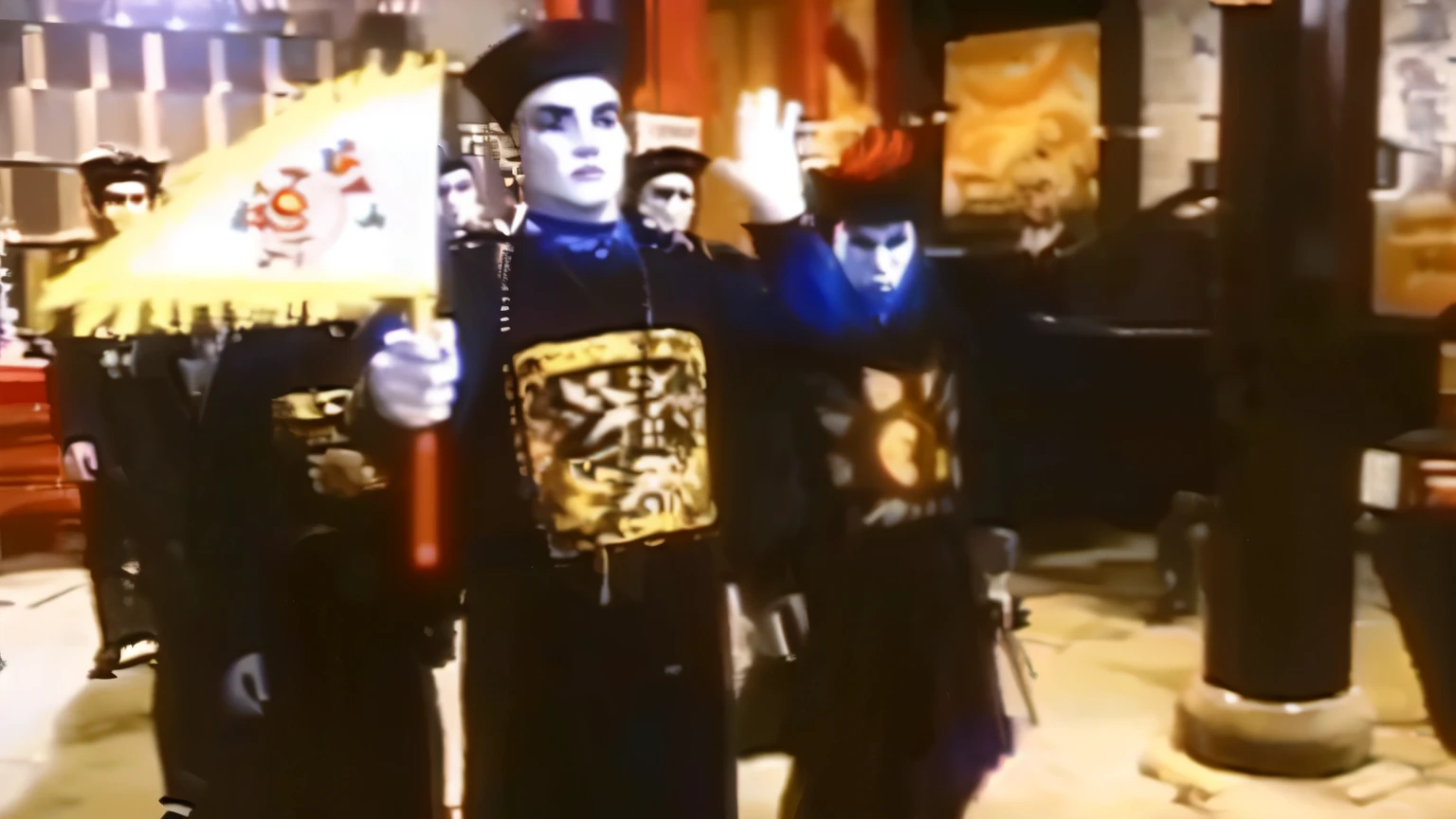 arafed image of two men dressed in costumes holding a sign, screenshot from the 1983 film, videotape still from 1985, antichrist dancing at studio 54, 1 9 8 6 movie screenshot, goth people dancing, the munster in the background, orthodox symbolism diesel punk, vhs screencap, classic kabuki