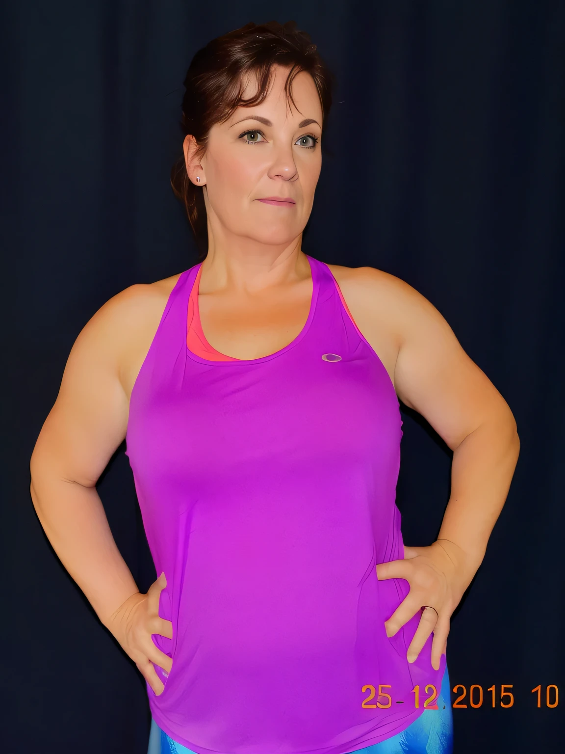 there is a woman in a purple tank top posing for a picture, frontal pose, wearing purple undershirt, fit pic, sweating intensely, sweating, t pose, folds of belly flab, 40 years old women, her face flushing and sweat, half-body shot, half - body shot, 40 years woman, violet tight tanktop