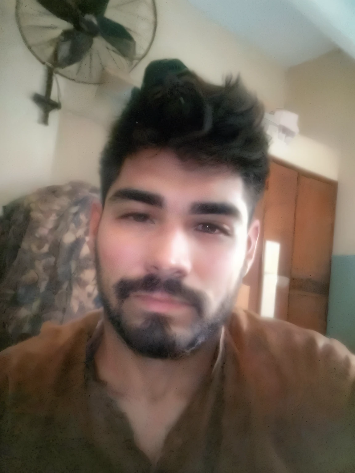 there is a man with a beard and a brown shirt, without beard and mustache, without beard, with accurate face, very very low quality picture, around 1 9 years old, with a small beard, about 3 5 years old, selfie photo, face picture, 4 0 years old man, with no beard, without mustache, uploaded, 2 7 years old