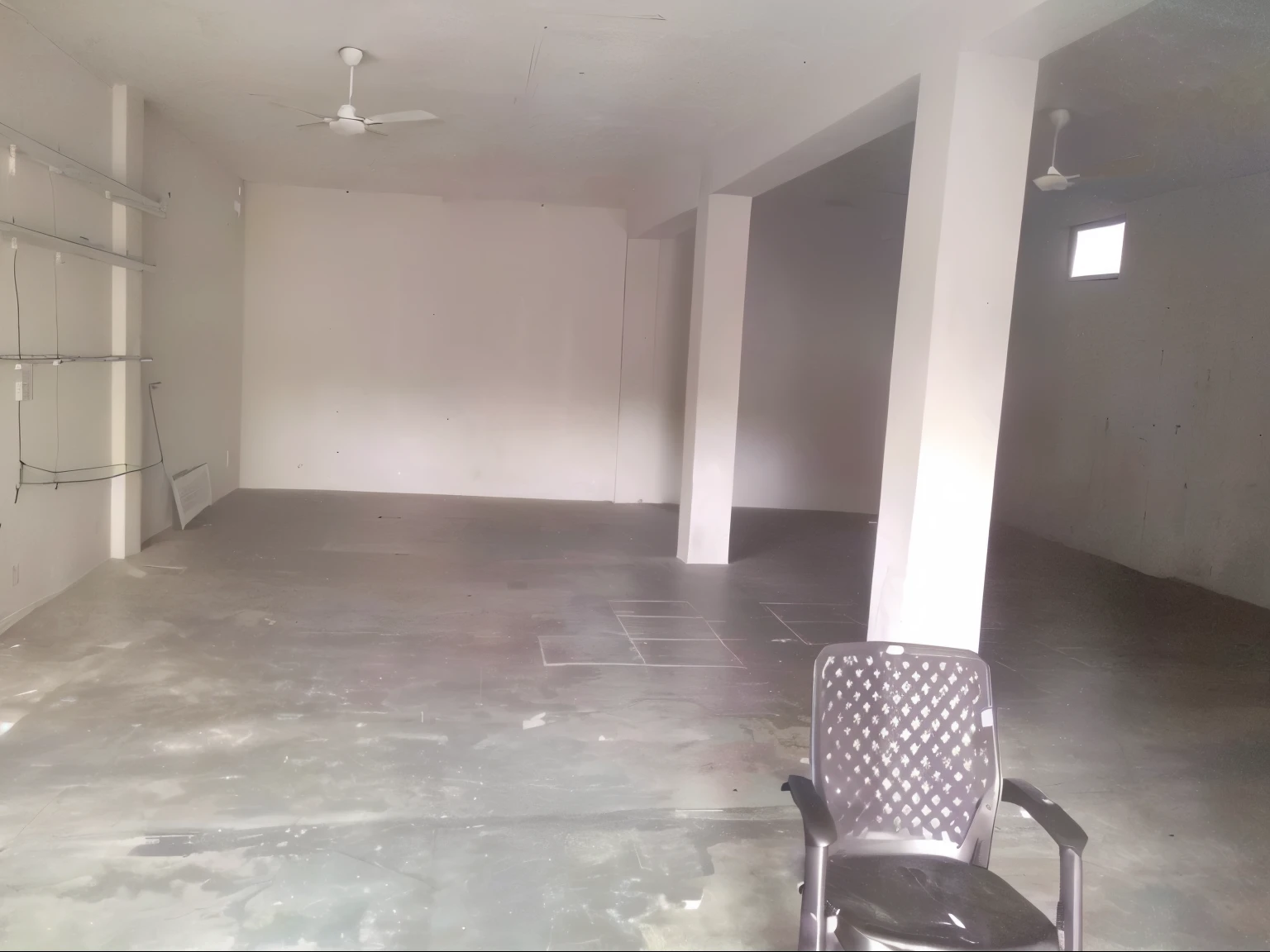there is a empty room with a chair and a fan, completely filled space, dark show room, interior view, ground level view, inside view, large open room, listing image, black show room, office/thrift store/social hall, 256x256, 2 5 6 x 2 5 6, large room, inside building, big open floor