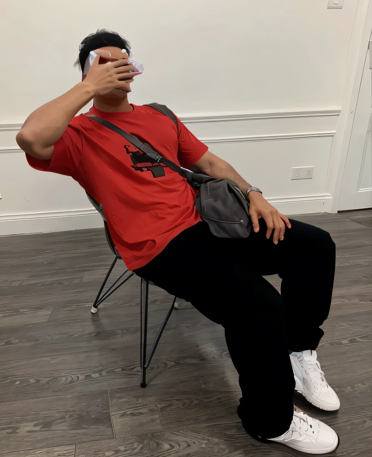 full length shot, latin male model. He is covering his face with his hand, 5 fingers.. He is using red t shirt, black cargo pant and white sneakers. has a crossbody backpack. He has a gray cap on top of his legs. High detail, 8k, bright - ar 9:16 - q:2 - v 5 - s750
