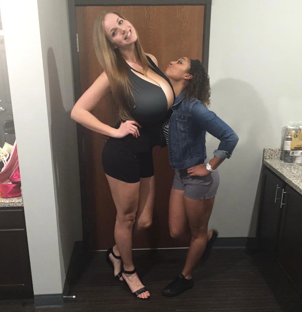 angled view, plain black shirt, (big giant enormous oversized massive huge colossal breasts:1.5), (gigantic sagging breasts:1.5), (very long thick full hair), (extremely long hair), symmetric breasts