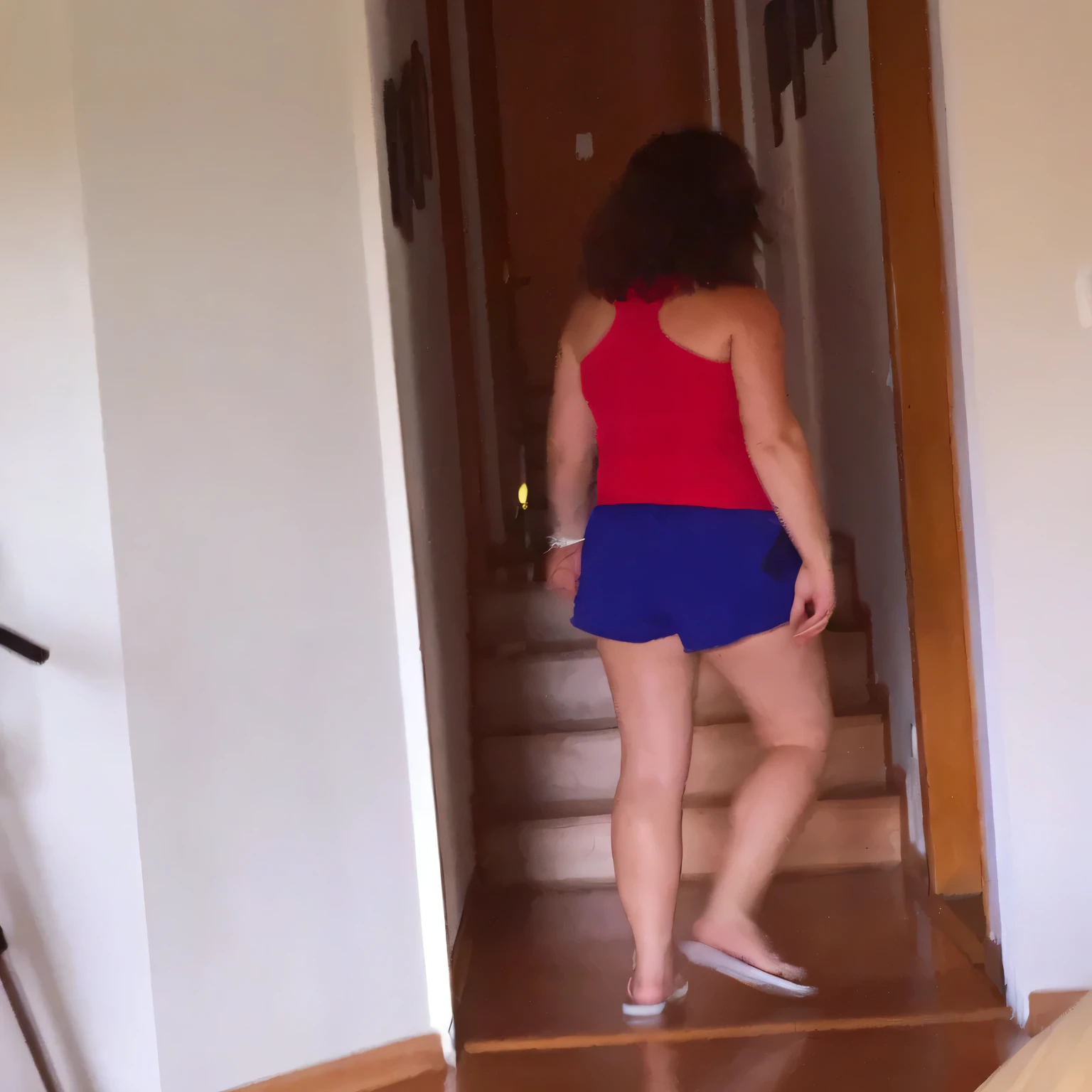 there is a woman walking down a flight of stairs in a house, side view of her taking steps, in shorts, wearing red shorts, coming down the stairs, wearing a camisole and shorts, view from the back, dressed in a top and shorts, walking away from camera, walking away from the camera, seen from the back, wearing a tank top and shorts