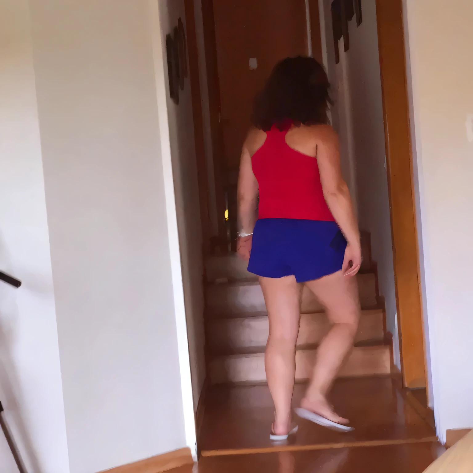there is a woman walking down a flight of stairs in a house, side view of her taking steps, in shorts, wearing red shorts, coming down the stairs, wearing a camisole and shorts, view from the back, dressed in a top and shorts, walking away from camera, walking away from the camera, seen from the back, wearing a tank top and shorts