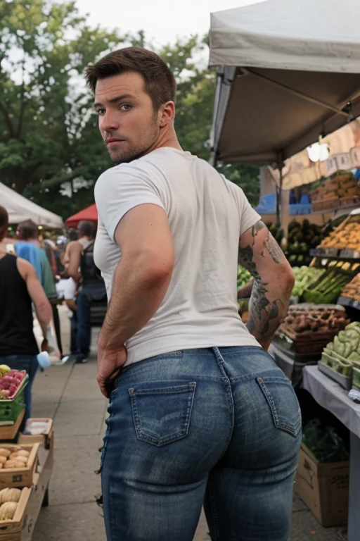 JordanBrandt, 35yo, wearing a t-shirt and jeans, at the farmers market, backside bent over