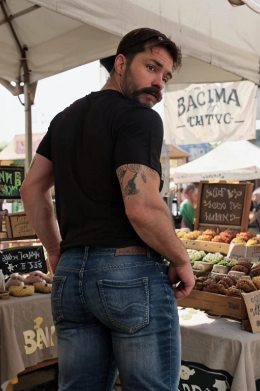 JordanBrandt, 45yo, short mustache and beard, wearing a t-shirt and jeans, at the farmers market, backside bent over