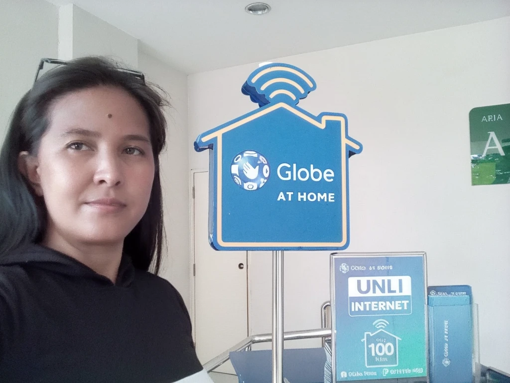 woman standing in front of a globe at home sign with a remote control, having a time of our un-life, at home, internet, home, my home, close-up photo, close - up photo, profile pic, mobile, profile image, profile photo, exclusive, globes, by Gina Pellón, global awarded, myself, by Robbie Trevino