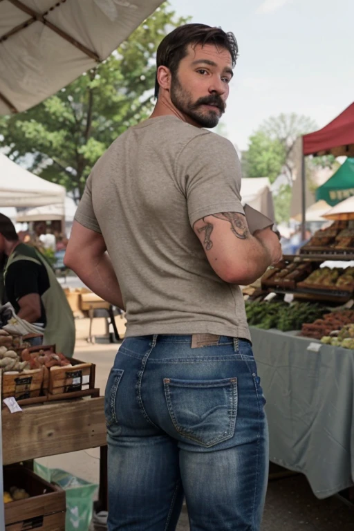 JordanBrandt, 45yo, short mustache and beard, wearing a t-shirt and  jeans, at the farmers market, backside bent over 