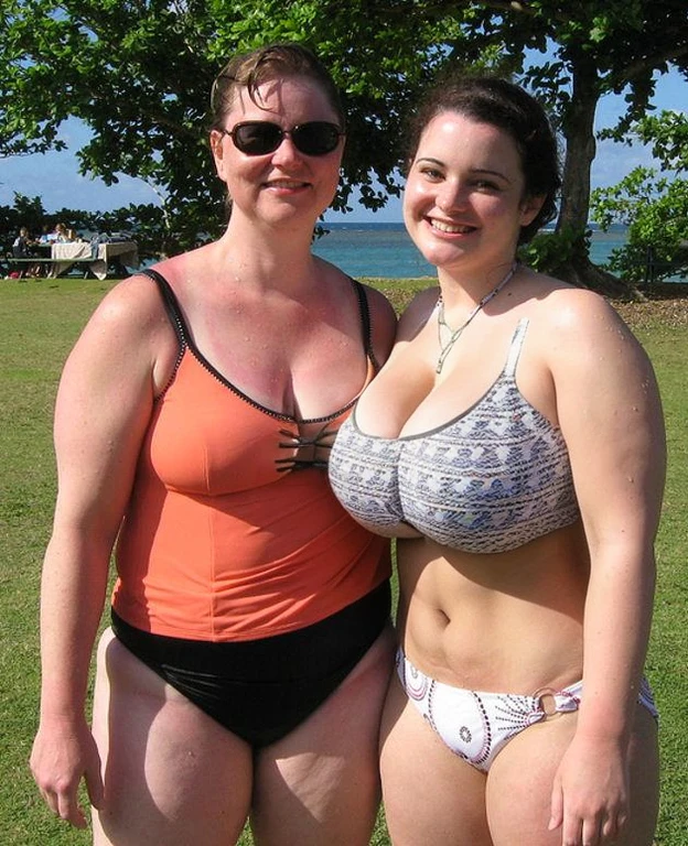 angled view, patterned swimsuit, cleavage, (big giant enormous oversized massive huge colossal breasts:1.5), (gigantic sagging breasts:1.5), symmetric breasts, slender