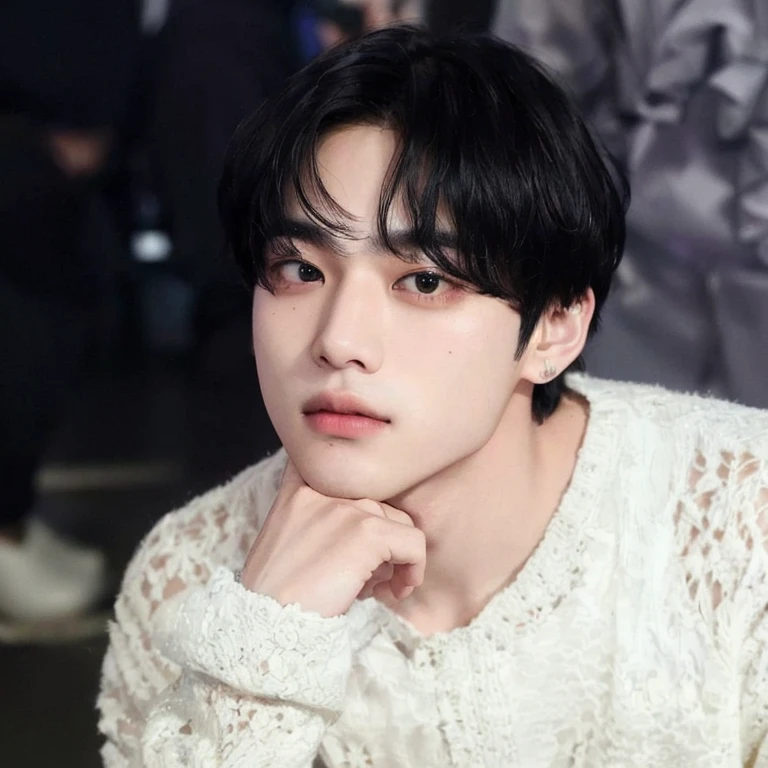 There is a man who is sitting with his hand on his chin, Kim Taehyung, de pelo negro, Taehyung, taken at the beginning of the year 2024, Kim Taehyung, his right eyelid is swollen, rostro tierno, ulzzang, extremadamente guapo, los labios carnosos, V de BTS.