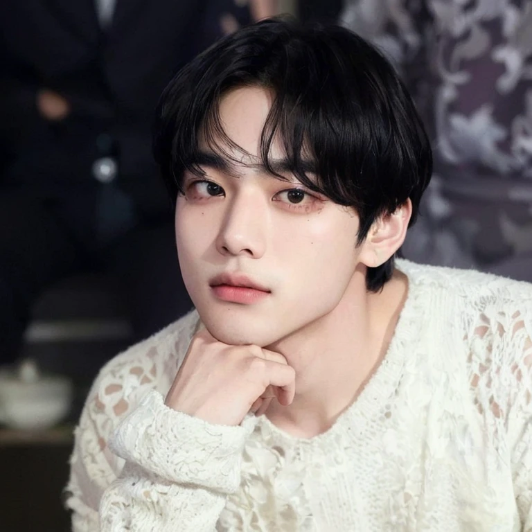 There is a man who is sitting with his hand on his chin, Kim Taehyung, de pelo negro, Taehyung, taken at the beginning of the year 2024, Kim Taehyung, his right eyelid is swollen, rostro tierno, ulzzang, extremadamente guapo, los labios carnosos, V de BTS.
