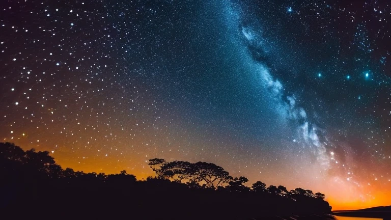 A crescent moon floats in the dark night sky