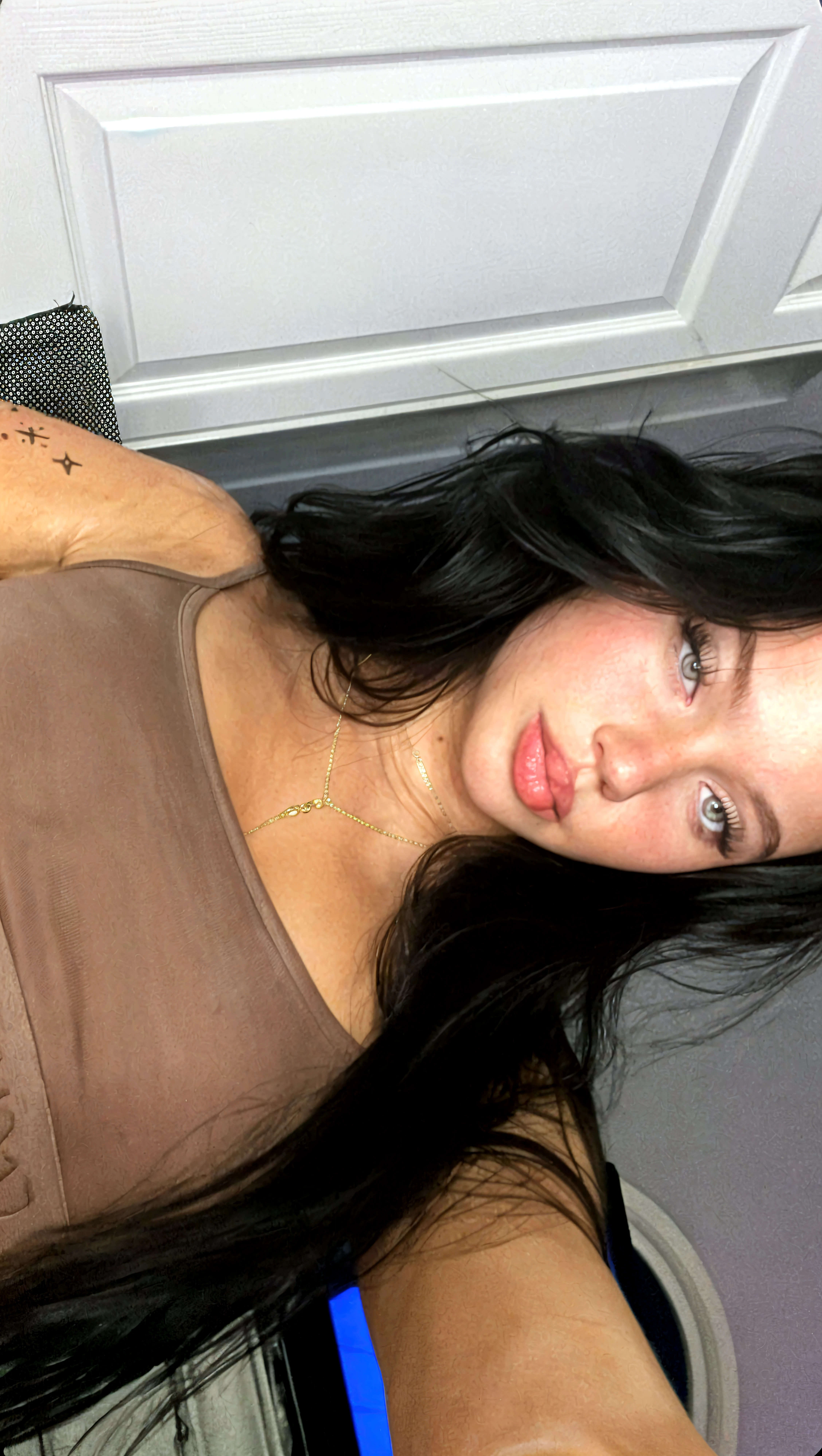 a selfie of a pretty young woman, taken with iphone camera, megan fox and angelina jolie look a like in nude
