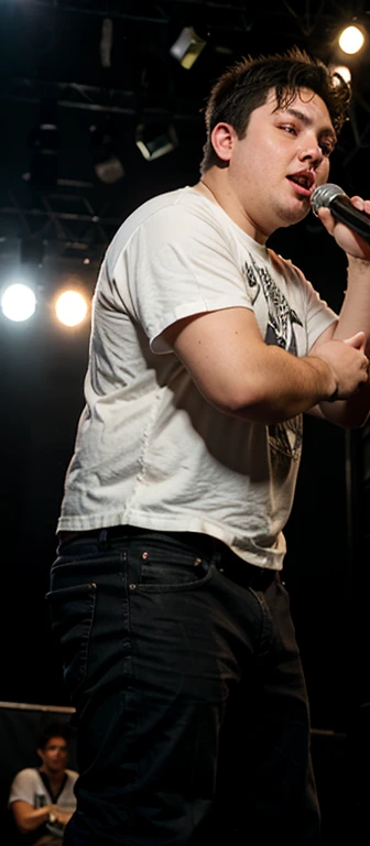 18 year old slightly overweight guy with black hair on stage at a rap battle