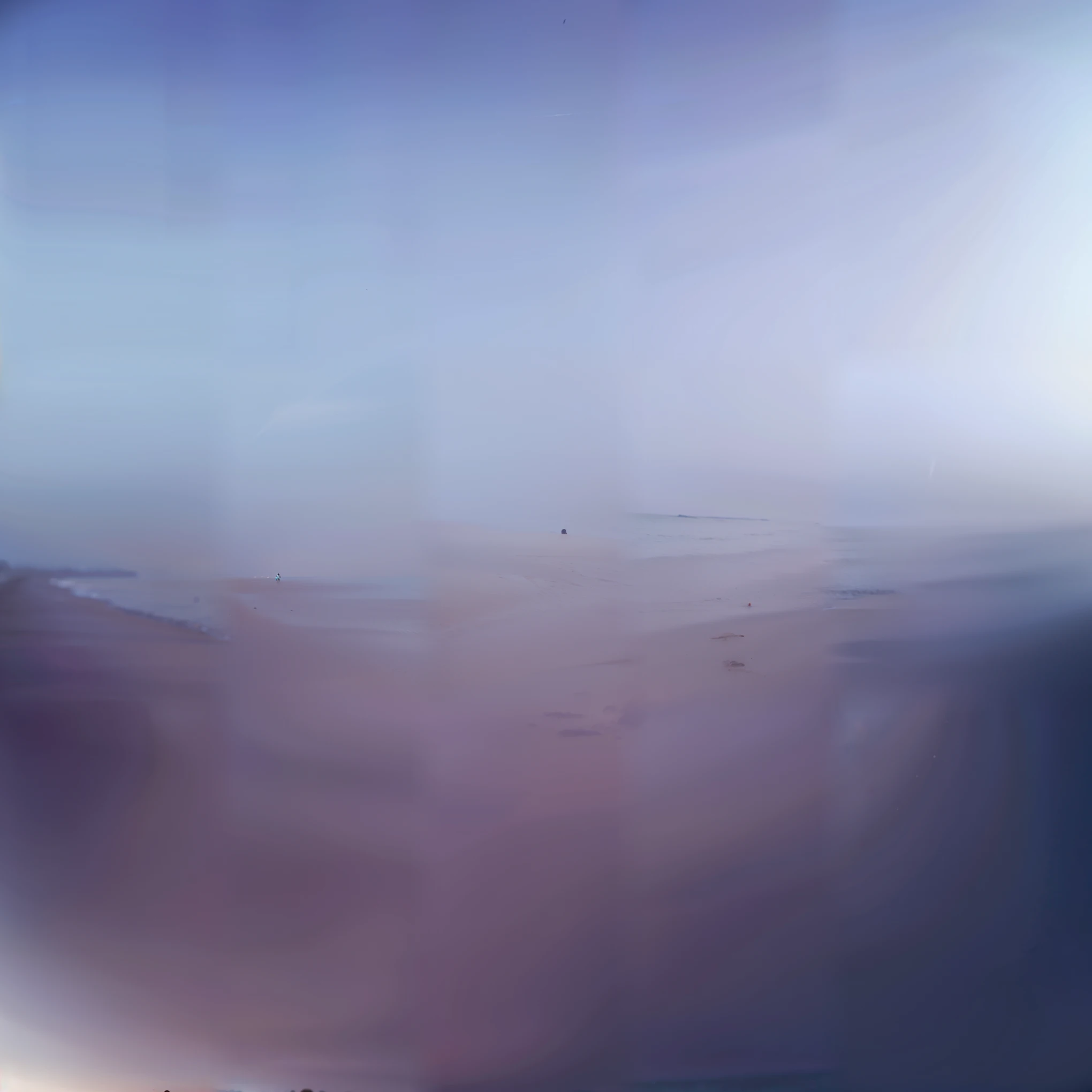 A little boy taking pictures on the beach