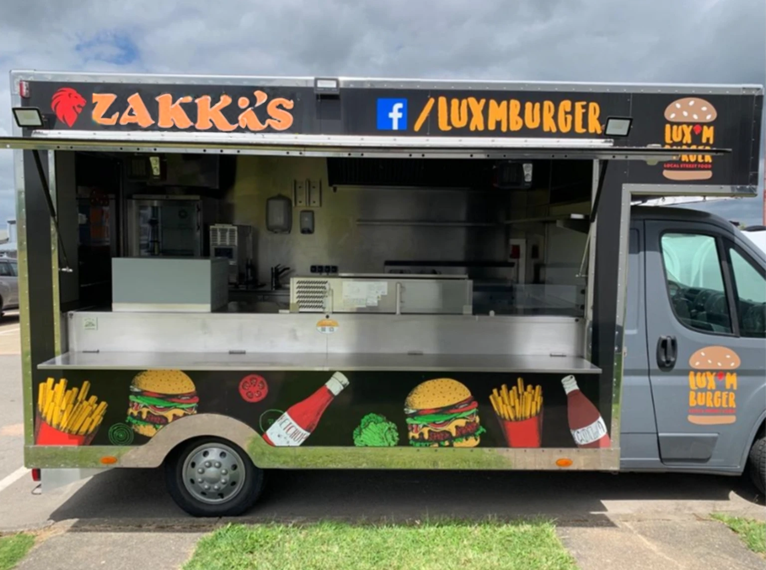 Write "At Zakk's" in orange color.