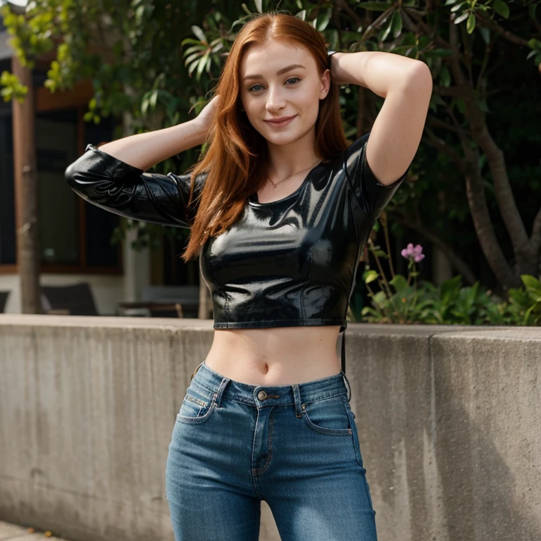 Sophie Turner wearing leather top and jeans and smiling