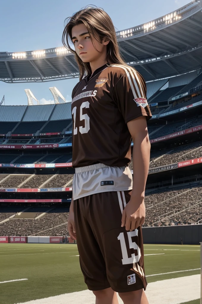 a 15 year old boy with long brown hair standing in a stadium wearing football clothes