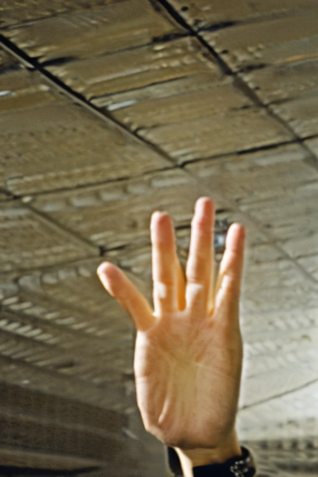 Photo of a hand showing 3 fingers camera pointing at the ceiling