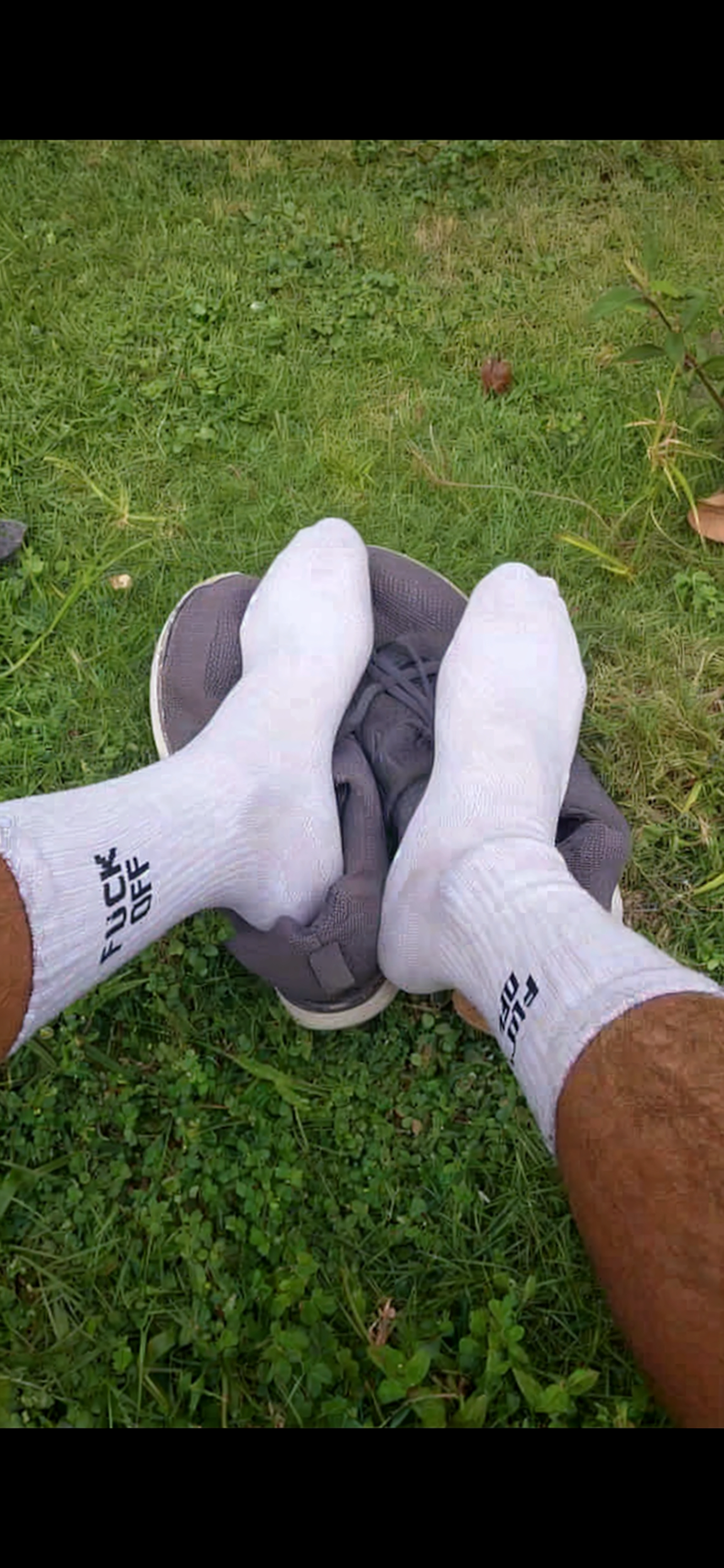 full body shot,young male with giant big feet , barefoot and tracksuit, destroy house with his giant feet, very huge soles, laughing face 
