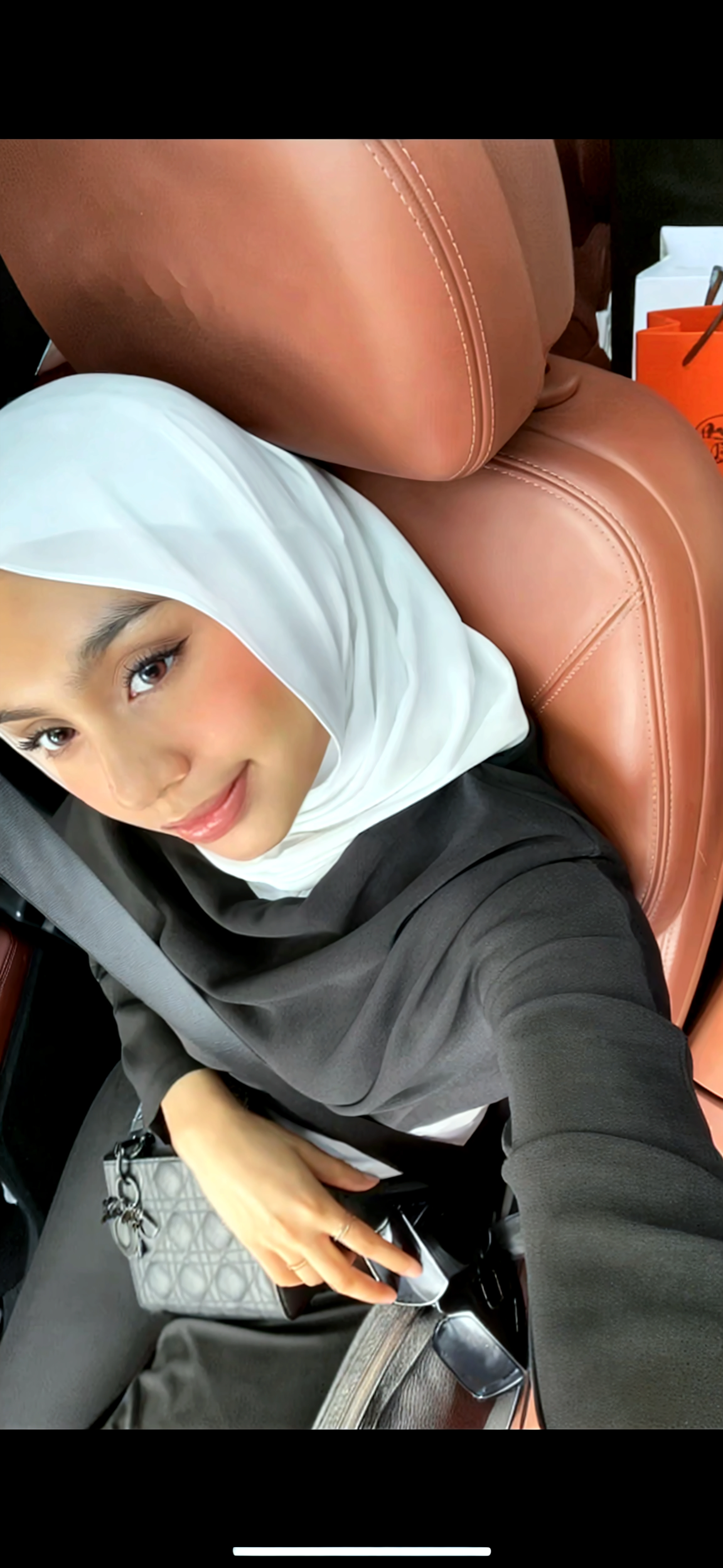 ((best quality)), ((masterpiece)), 2 girl, perfect face, indonesia, white hijab, white skin. sharp nose, smile, half body, garden, selfie, Undressing nude breasts and vagina, leaning in the mat, her hand in the knee. Horny face.