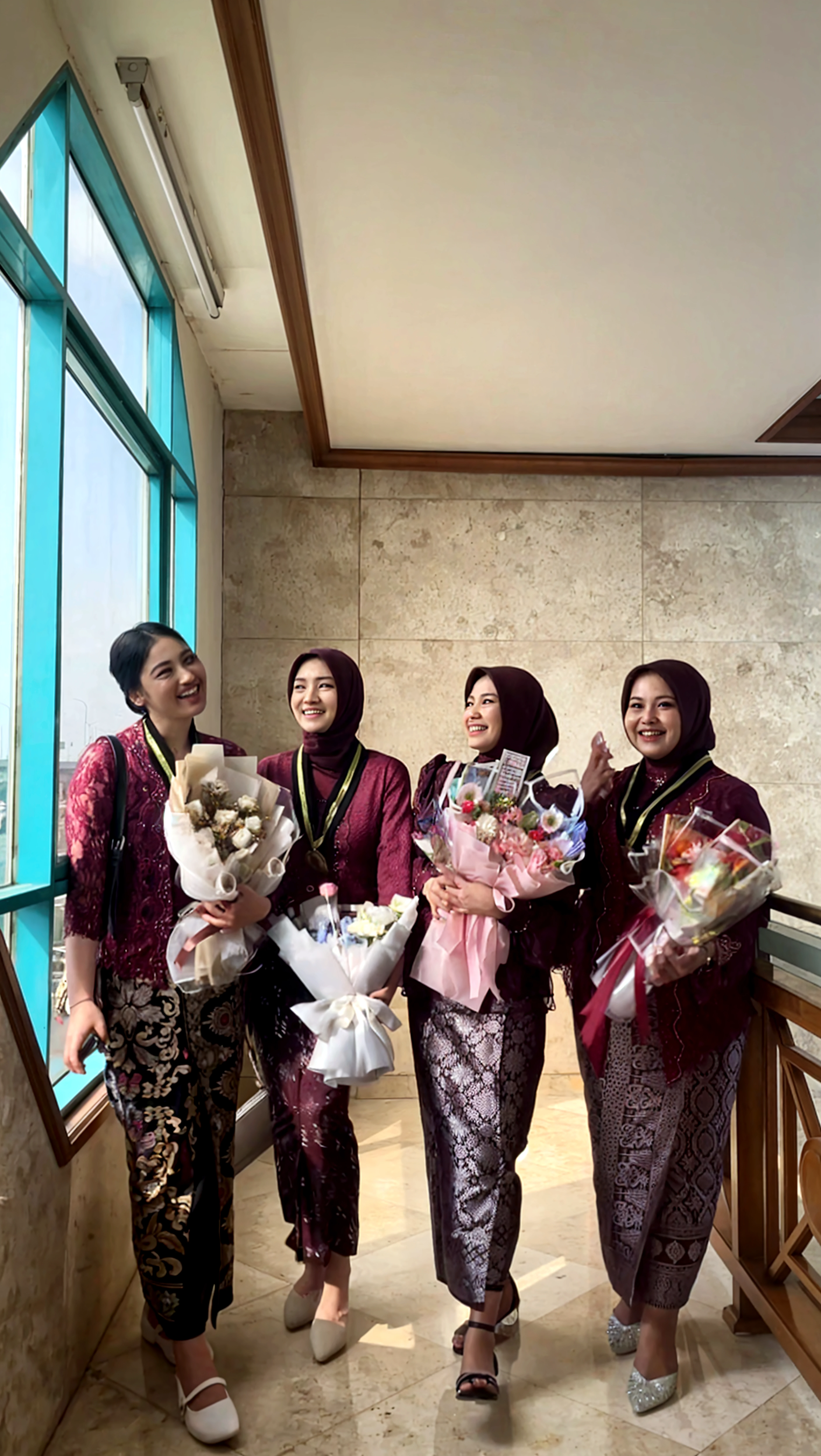 photo of a young Indonesian family made of acrylic plaque, father and mother, mother wearing hijab and 1 , smiling, acrylic's shape following the curve of the body, located on a white table decorated with dried flowers beside it, bright lighting, separately on the top wall there is a neon sign "Happy Family" , ultrarealistic, HD