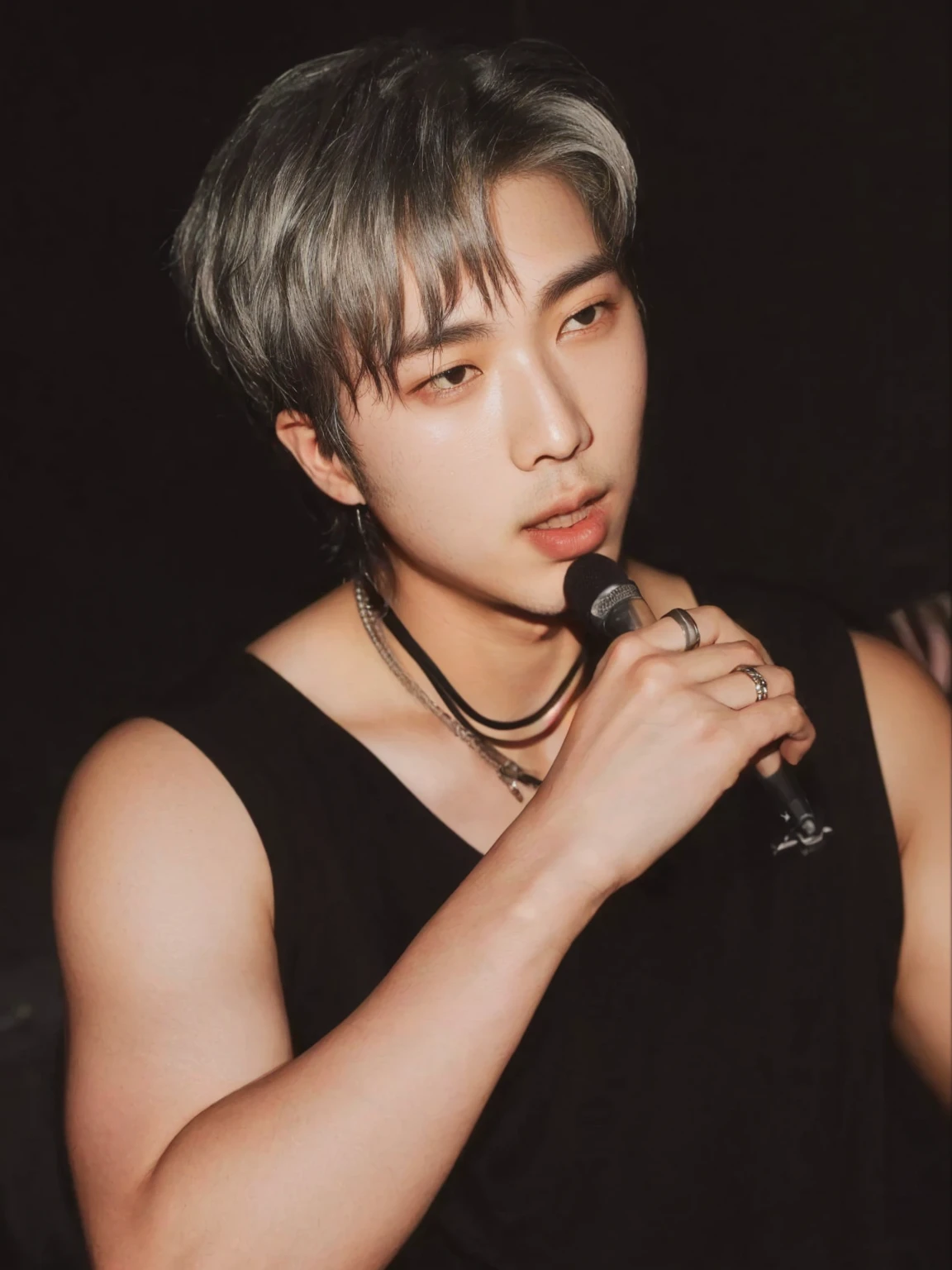 Arafed man in a black shirt holding a microphone and looking at the camera., hyung Kim namjoon labios carnosos, escaneo de revista, Hong June Hyung, escaneo de alta calidad, steven jung, foto de revista, chico de brazos fuertes suspirando, mirada coqueta, namjoon bts