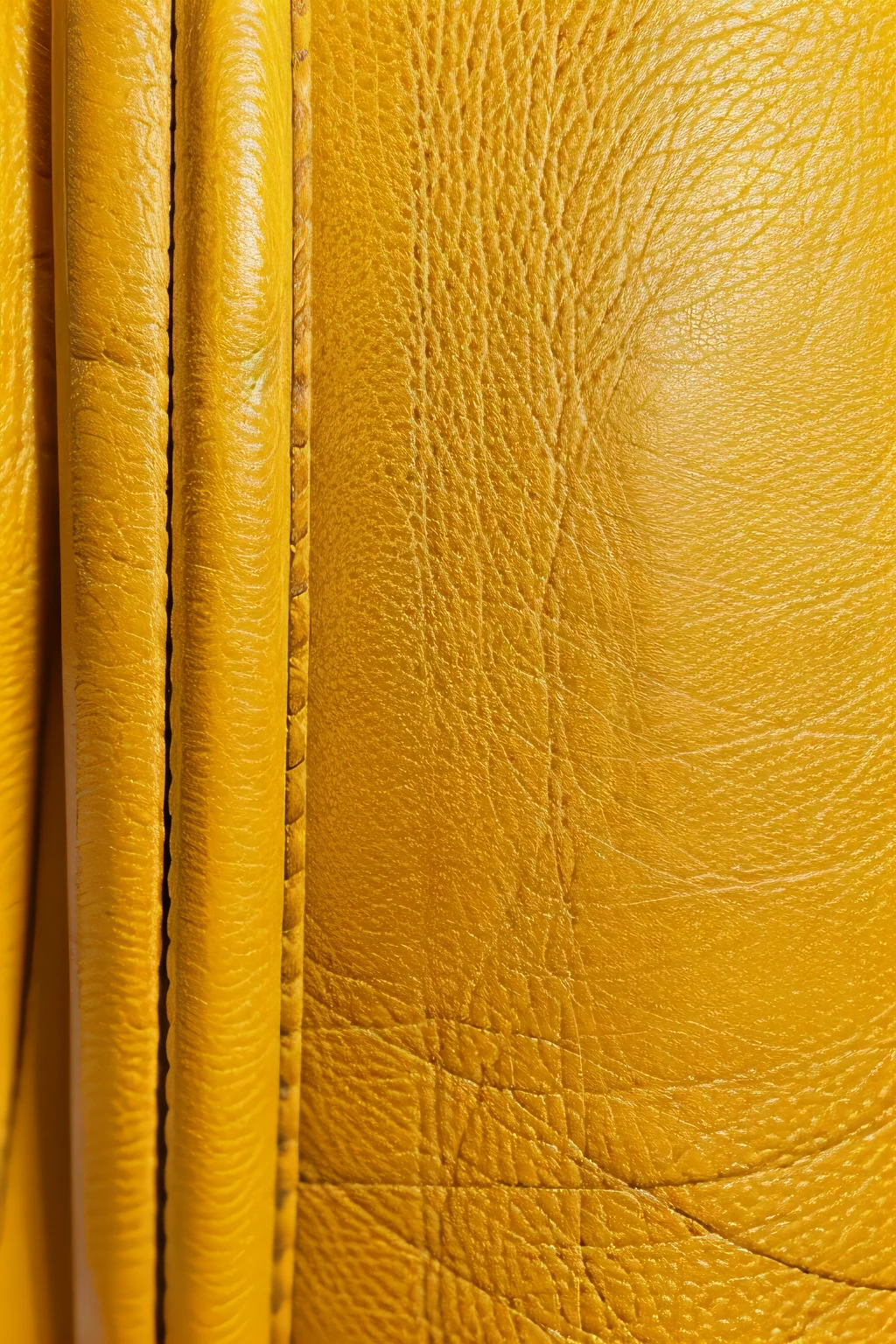 Create an image of the most beautiful yellow textured leather, laying flat and uniform. Ensure the texture is clearly visible and of high quality, with no creases, folds, or imperfections. The image should be plain, showcasing only the textured leather surface in a uniform manner