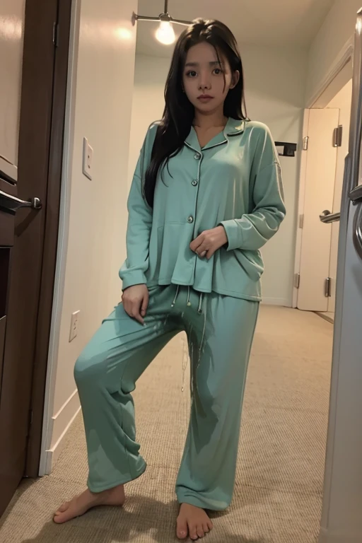 British lady with long black hair sitting on bed wearing yellow green pajamas, selfie 